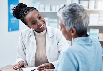 Pharmacy, healthcare or medical with a customer and black woman pharmacist in a dispensary. Medical, insurance and trust with a female medicine professional helping a patient in a drugstore.